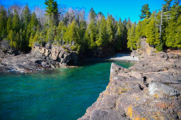 istock Beautiful view of a long blue lake stream between rocks in a forest 1459558774