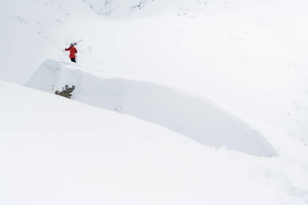 istock Man hiking the snow-capped mountains at daytime 1459558819