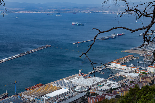 View from the Rock of Gibraltar to the bay of Gibraltar full of ships. Incredible skyline, blue sky with amazing clouds.