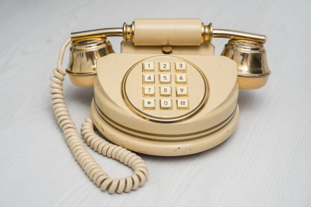 istock Old vintage telephone on the white wooden table 1459562017