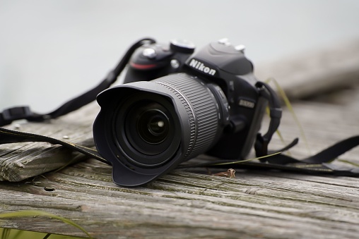 schmalensee, Germany – May 27, 2022: A closeup shot of the black Nikon Camera placed outdoors