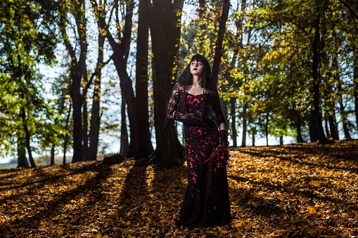 A scary corpse bride in the autumn forest