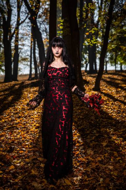 istock Vertical shot of a scary corpse bride in the autumn forest 1459563457