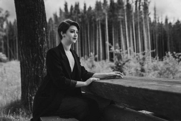 istock Attractive woman in black in a forest 1459564276
