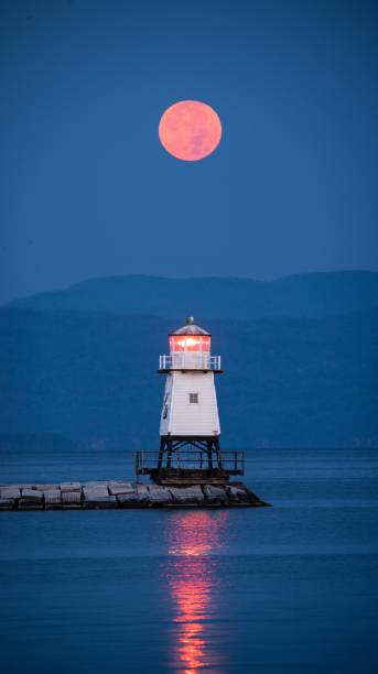 istock Mesmerizing view of the moon setting over Lake Champlain and a lighthouse, in Burlington, Vermont 1459565662
