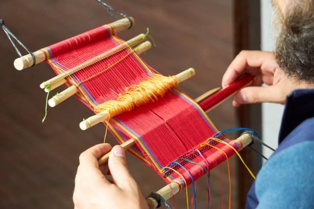 istock Tourist learning back strap weaving in Guatemala 1459566440