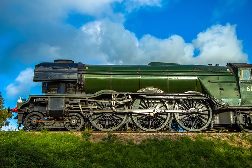 Swanage, United Kingdom – October 24, 2022: A side view of the old-fashioned Flying Scotsman train against the blue sky