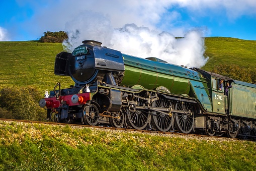 Swanage, United Kingdom – October 24, 2022: The old-fashioned Flying Scotsman train steaming on the railway
