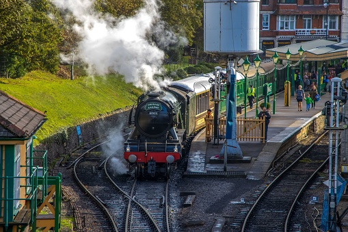 Swanage, United Kingdom – October 24, 2022: The old-fashioned Flying Scotsman train steaming on the railway before the departure