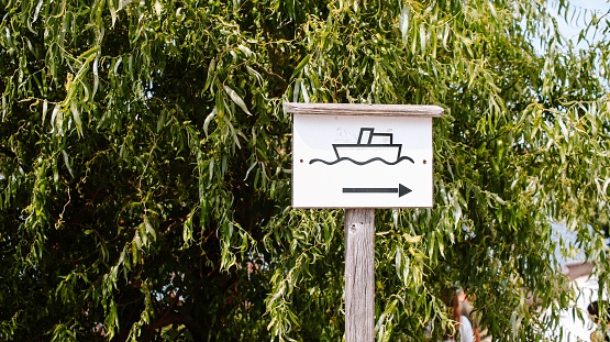 A boat parking sign with the green tree in the background on the territory of Gmunden fortress in Austria