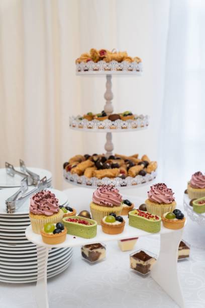 istock Vertical shot of an assortment of dessert pieces on a white table 1459567708