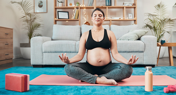 Pregnant woman, yoga and medication on home floor for balance, mental health and mindfulness for health and wellness with lotus exercise workout. Female meditate for zen, peace and calm in pregnancy