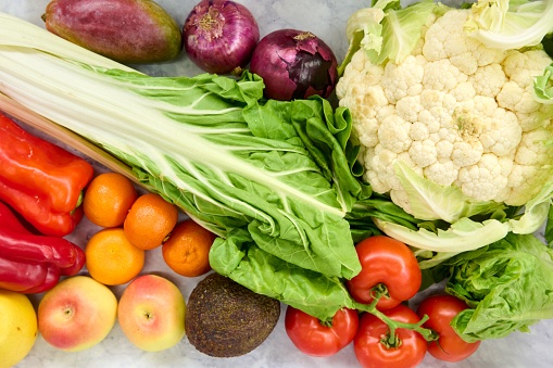 A heap of colorful, fresh, raw vegetables awaiting preparation.