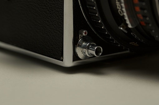 A closeup shot of a Hasselblad retro vintage camera on a white surface