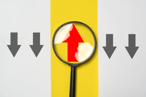 The word compliance as seen through a magnifying glass. Photographed with a very shallow depth of field.