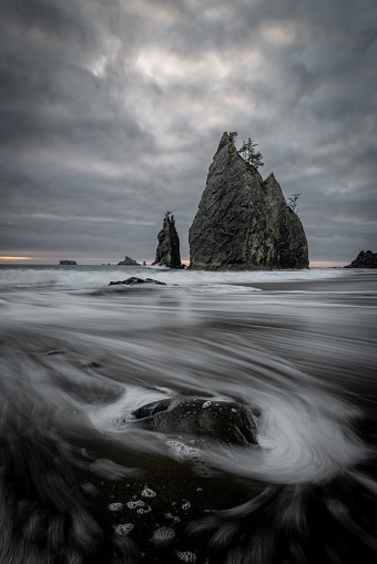 A vertical shot of the cliffs at Rialto Beach on a cloudy day. Olympic National Park, Washington, USA.