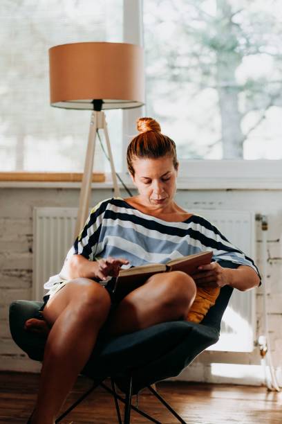 istock Caucasian female reading book at home 1459575466