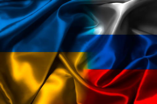 Half of Ukraine flag and Russia flag  on silk fabric for both countries political conflict and war concept.