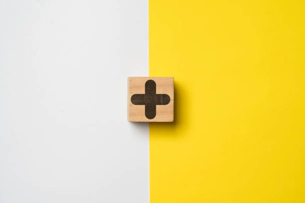 istock Plus sign on white and yellow background for positive thinking mindset of personal development benefit and health insurance concept. 1459575608