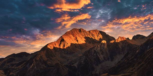 istock Panoramic shot of the Pyrenees mountain range illuminated by sun rays at sunset in Europe 1459576108