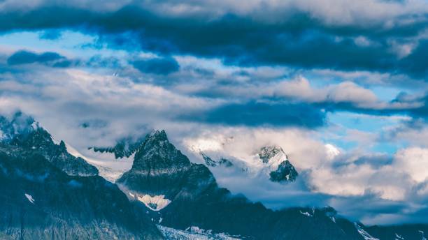 Beautiful scenery of Meili snow Mountain with clouds in Deqen County, Yunnan Province, China A beautiful scenery of Meili snow Mountain with clouds in Deqen County, Yunnan Province, China meili stock pictures, royalty-free photos & images