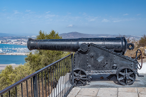 Military Heritage Centre of Gibraltar. Old historical cannon battery at the top of The Rock of Gibraltar. No people, beautiful sunshine, amazing blue sky above.