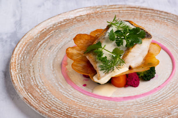 istock Closeup of pike perch with vegetables on plate 1459577977