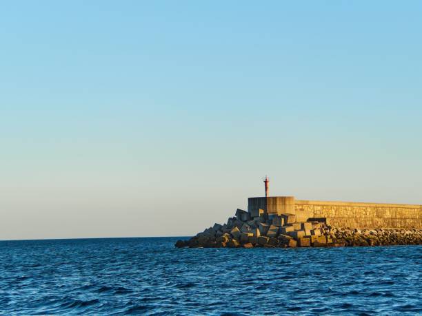 istock Breakwater with broken concrete blocks in the sea 1459578925
