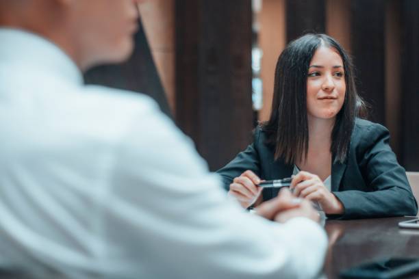 istock Female manager analyzing and studying the contracts and reports of her client at a table 1459579022