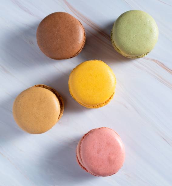 istock Vertical top view of colorful macarons on a table 1459579302