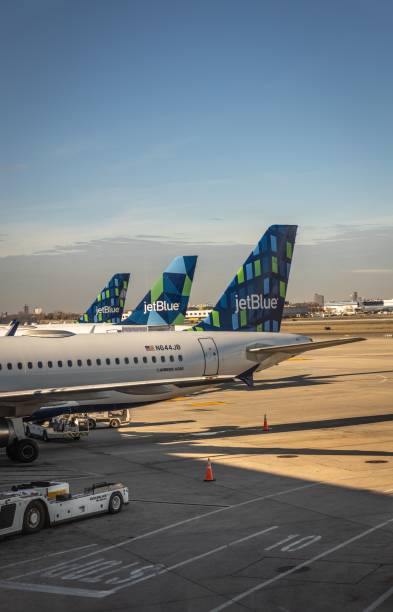 Vertical shot of Jetblue airways planes in a row at John F Kennedy Airport in New York New York, United States – December 02, 2022: A vertical shot of Jetblue airways planes in a row at John F Kennedy Airport in New York airfoil photos stock pictures, royalty-free photos & images