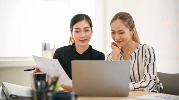 istock Two professional Asian businesswomen analyzing financial data, working together. 1459581943
