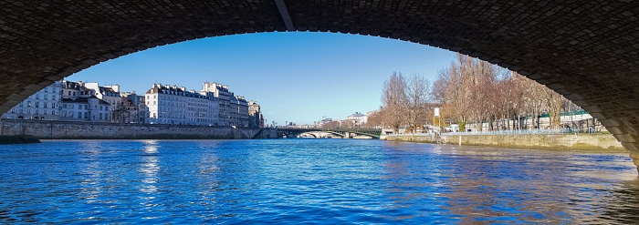 Paris, ile saint-louis, view under the Pont-Marie bridge, with the Arcole bridge in background, beautiful ancient buildings