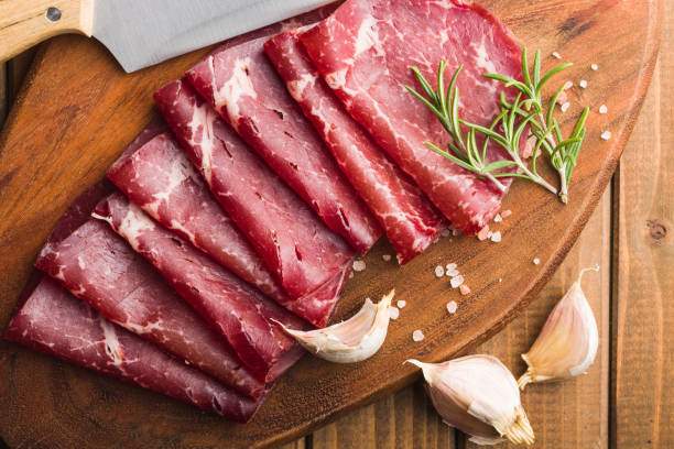 istock Smoked bresaola. Italian appetizer. Dried beef meat on cutting board. 1459584928