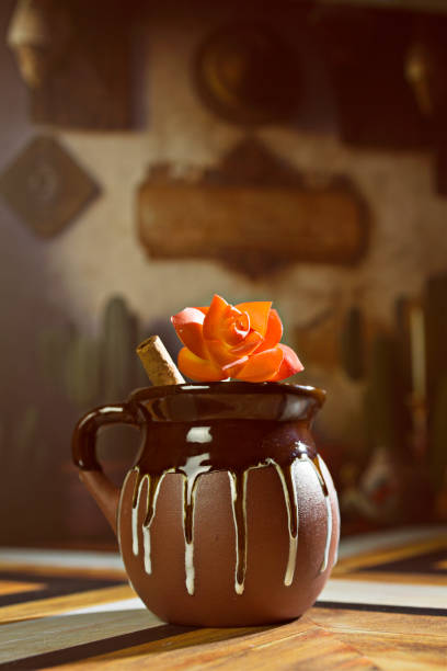 istock Mexican Champurrado Hot Chocolate in Traditional Rustic Clay Jarritos Mug with Cinnamon Stick 1459585741