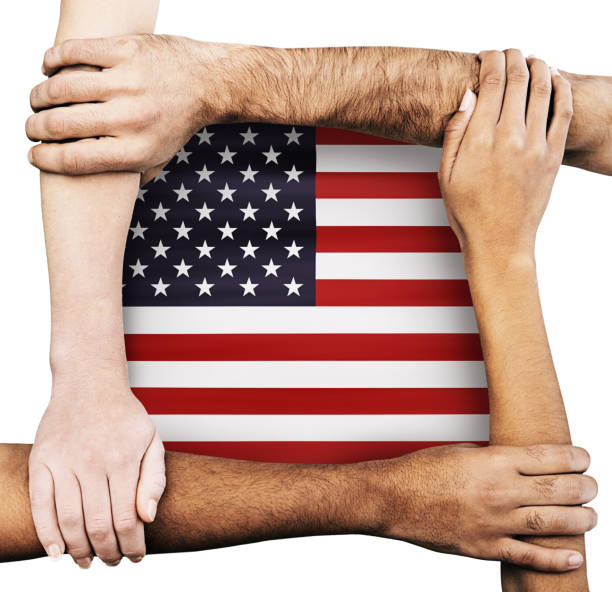 istock American flag surrounded by diverse group of clasped hands and arms 1459588750