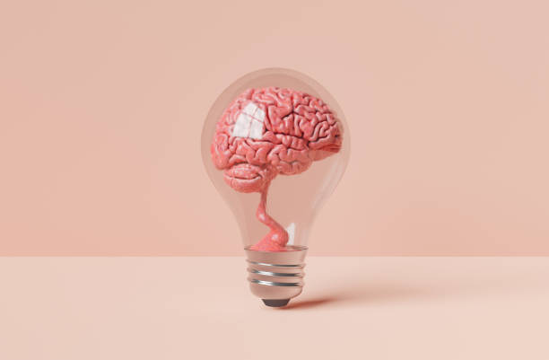 AI generated image of brain in light bulb 3d illustration of brain inside of transparent light bulb placed on table against pink background ai generated image stock pictures, royalty-free photos & images