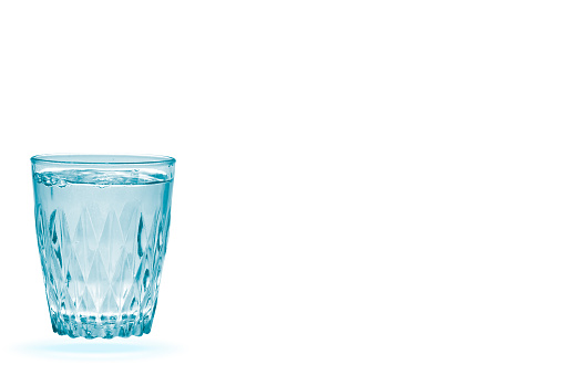 Drinking glass mineral water cut out on white background. Healthy drink concept.