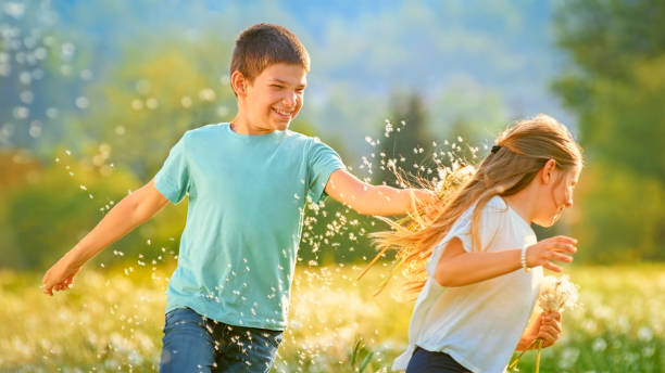 istock Children playing with dandelion flowers 1459591641