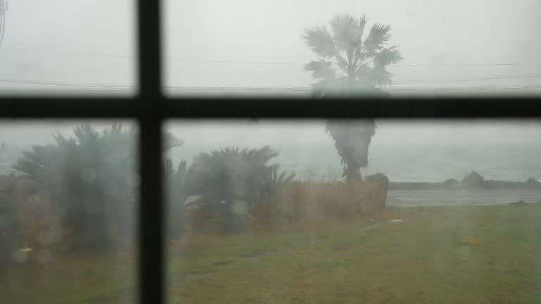 Looking at the rain falling out of the window in a cozy house in Jeju Island, Korea.