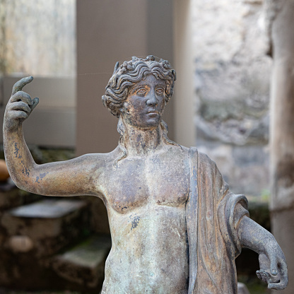 bronze statue of man in Herculaneum, ancient roman town in Italy, destroyed by eruption of vulcano Vesuvius in AD 79