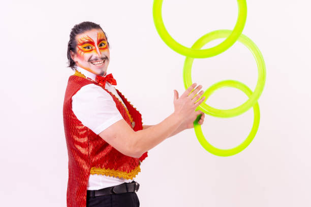 istock Smiling juggler juggling hoops isolated on white background 1459596969