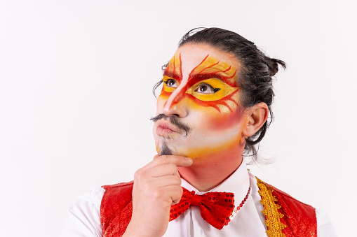 Portrait of smiling juggler with painted clown face isolated on white background