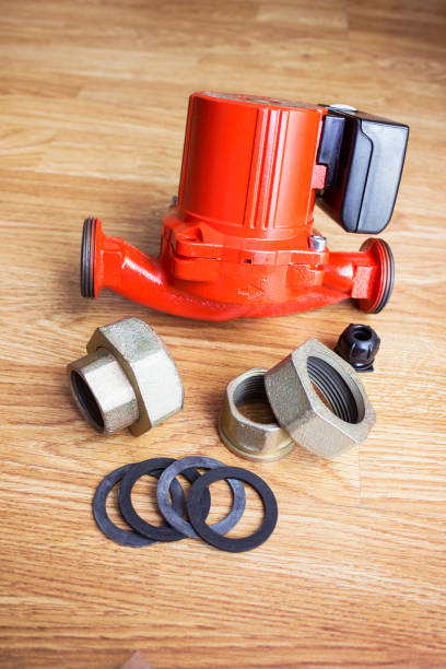 istock Red circulation pump for heating system and fasteners for it lies on the floor 1459600153