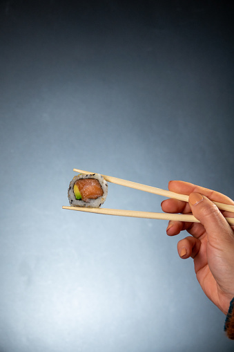 Sushi uramaki sashimi and chopsticks