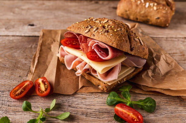istock A delicious sandwich with ham, prosciutto, cheese and vegetables 1459605022