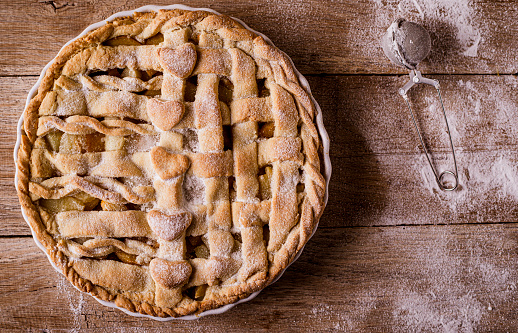 Homemade apple pie on wooden background