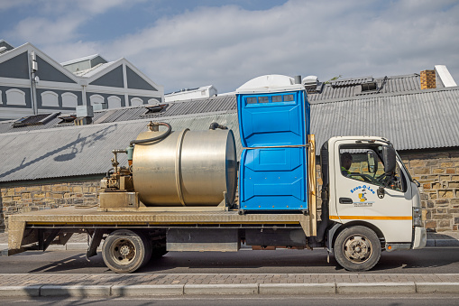 Cape Town, South Africa - December 14th 2022: Truck with water tank and portable toilet at the Victoria and Alfred Waterfront area