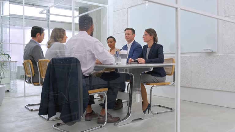 DS People in a business meeting in a room with glass walls