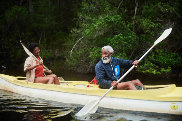 istock Couple enjoying paddling a double canoe down a river together 1459606563